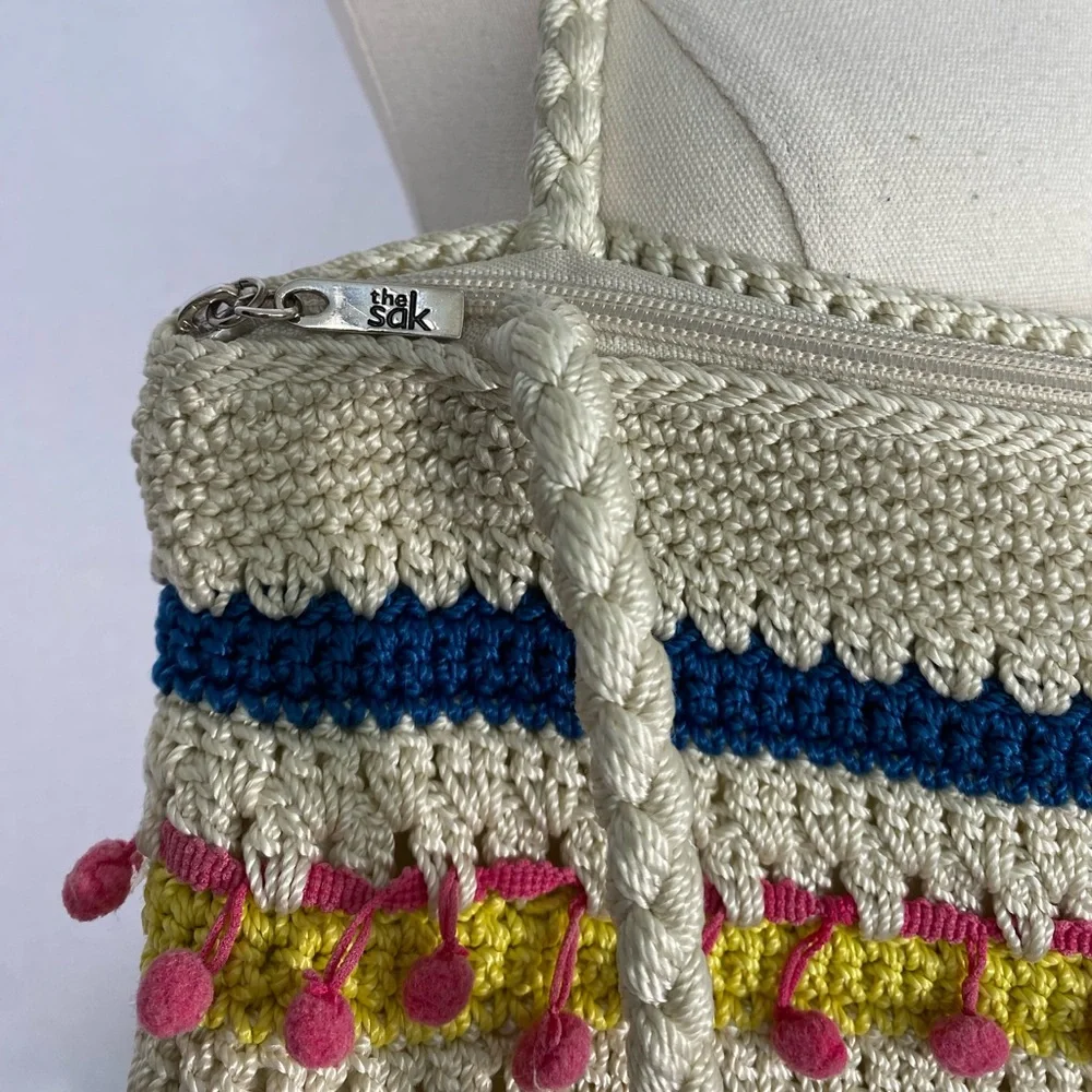 The Sak crocheted striped shoulder bag with pink pom-poms Casual Classics
